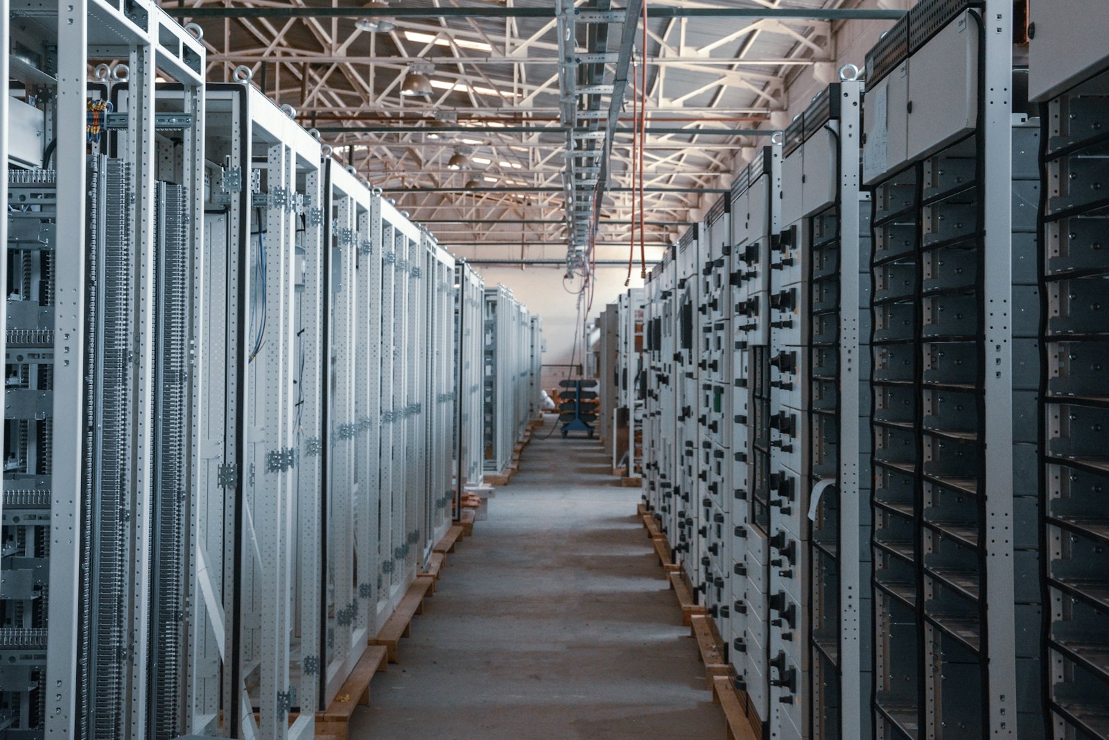 Long aisle of network equipment racks in a data centre